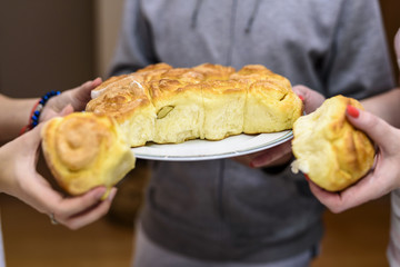 Family hands turning bread, Christmas traditions