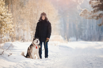 Training of dogs. Man is training her dog on street in winter