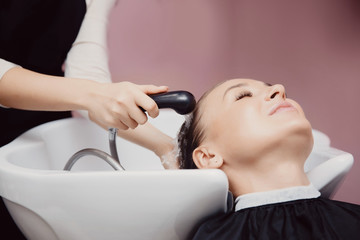 Obraz na płótnie Canvas Salon hair salon, master washes hair and massages girl's head