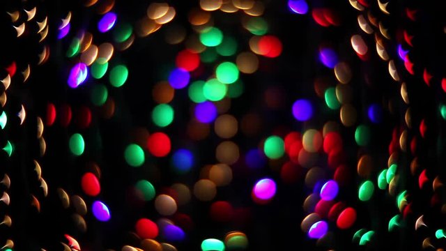 Abstract holiday background with magic blinking lights. Christmas and new year twinkling decoration. Celebration spirit in merry flashing colorful specks on dark night backdrop in full HD clip.
