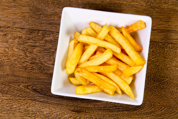 French potato over wooden background