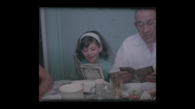 1961 Jewish family reads Haggadah at Passover Seder