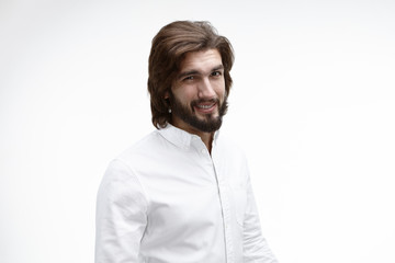Horizontal portrait of doubtful young bearded Caucasian businessman looking at camera in indecisiveness and hesitation, expressing his doubts concerning risky investment, saying: I don't know