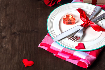 Festive table setting for Valentine's Day with fork, knife and hearts