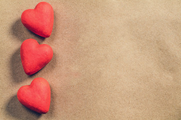 Red hearts on a brown paper background. Valentine's day