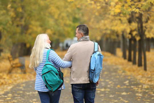 Mature couple taking walk in park
