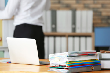 Stack of documents on office employee's table, closeup