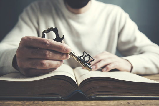 man hand key and book