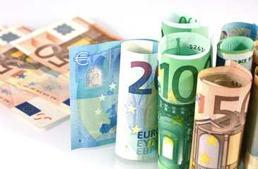Euro banknotes rolled on a white background
