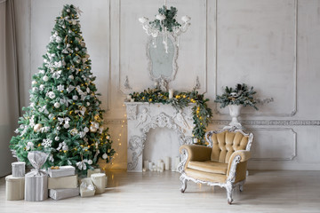 Christmas morning . classic apartments with a white fireplace, decorated fir tree, sofa, large windows and chandelier.