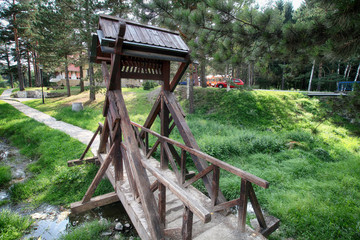 Fototapeta na wymiar Small wooden bridge in the park on mountain.