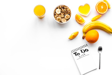 Morning habits of successful people. Healthy breakfast porridge with fruits and planning the day. White background top view copyspace