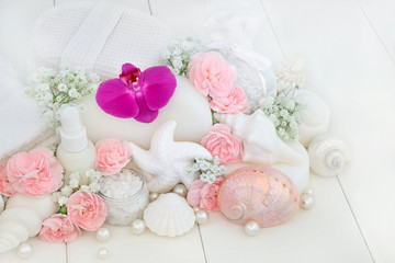 Beauty treatment cleansing and ex foliation products with orchids and carnation flowers, ex foliating salt, body lotion, seashell soaps, sponges, wash cloths, decorative shells and pearls.