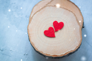 Two felted hearts on a wooden background, Valentine postcard concept