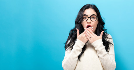 Surprised young woman posing on a solid background