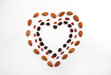 heart shaped mandala of dried fruits and nuts - symbols of jewish holiday Tu Bishvat