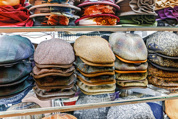 winter male caps and other headdress on showcase in shop