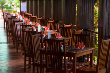 empty tables with pink napkins on the veranda in the early morning