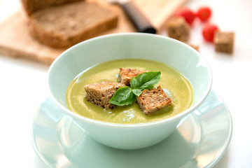 Pea cream soup on the dinner table