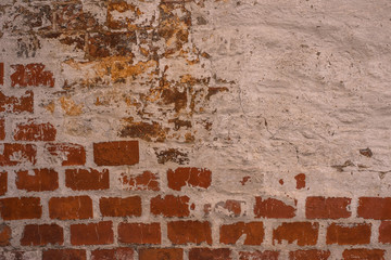 Brick wall with the remains of white paint - beautiful vintage grunge background