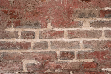 Brick wall with the remains of white paint - beautiful vintage grunge background