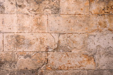 Ancient collapsing brick wall, vintage grunge background, texture