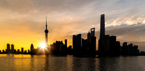 Fototapeta premium Sunrise of Shanghai skyline Pudong building most prosperous urban groups of panoramic view in the morning. Shanghai China City scape of business district trade zone.