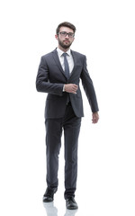 confident businessman goes forward. photo in full growth.