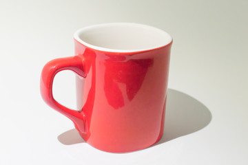 Empty red and white coffee cup on a white background