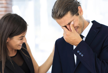 young businessman with tears of joy and his business team