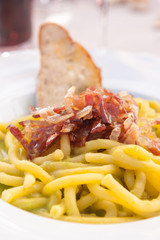 Plate of bigoli (italian pasta) with speck and peas cream, Cortina D'Ampezzo, Italy