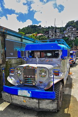 Filipino grey-blue dyipni-jeepney car stationed in Banaue town-Ifugao province-Philippines. 0083