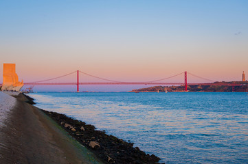 Fototapeta premium 25th of April Bridge (The 25 de Abril Bridge, Ponte 25 de Abril) is a suspension bridge connecting the city of Lisbon, capital of Portugal, to the municipality of Almada