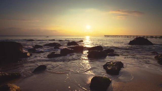 Sunrise on the sea rocks and beautiful clouds, video
