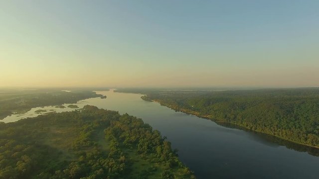aerial view of river at sunrise 4K, forest and river in morning mist, Very high view of the river forest at sunrise, Aerial view of mystical river at sunrise with fog