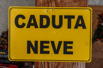 Sign saying "Caduta Neve" (beware of the falling snow),  Cortina D'Ampezzo, Italy