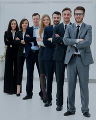 Obraz premium Business team in a line smiling at the camera