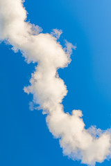 thick white smoke on a background of blue sky