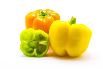 Green, yellow and orange pepper are isolated on a white background