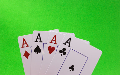 Four Aces on a Green Background