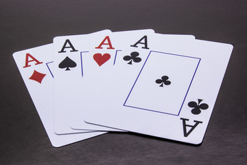 Four Aces on a dark background