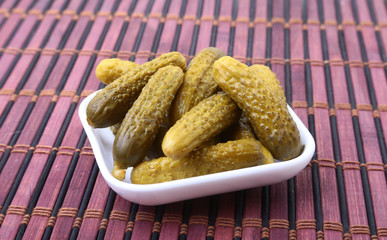 Pickles. Bowl of pickled gherkins cucumber with copy space. Cornichons.