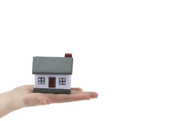 building, mortgage, real estate and property concept - close up of hands hold house model.with copy space