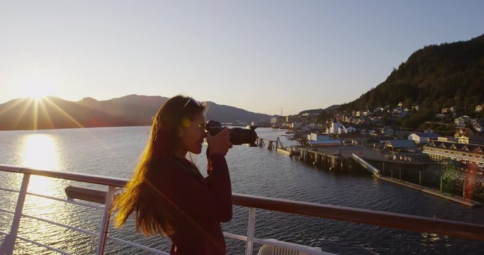 Cruise ship passenger photographing Alaska city of Ketchikan from cruise ship deck while sailing Inside Passage. Ketchikan is a famous Alaska cruise ship destination for tourist sightseeing.