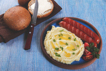 Grilled sausages with mashed potatoes close up on table 