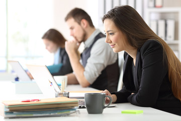 Three office workers working