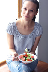 Obraz na płótnie Canvas A beautiful girl eating healthy food. Beautiful girl