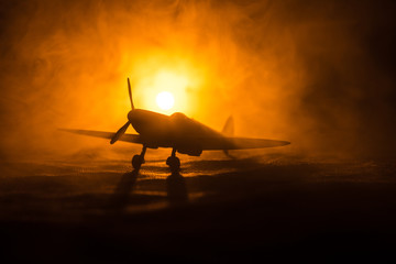 British jet-propelled model plane in possession. Dark orange fire background. War scene.