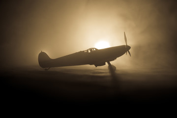 British jet-propelled model plane in possession. Dark orange fire background. War scene. - obrazy, fototapety, plakaty