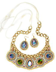 Handmade jewelry necklace with crystals and earrings set, blue, gold, cyan colors with ribbon tape. Beauty and fashion style women accessories design, colorful outfit, object isolated white background
